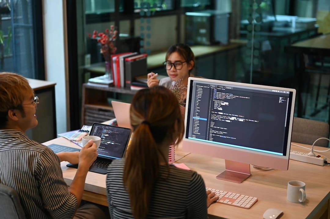 Developer working at workspace with multiple monitors