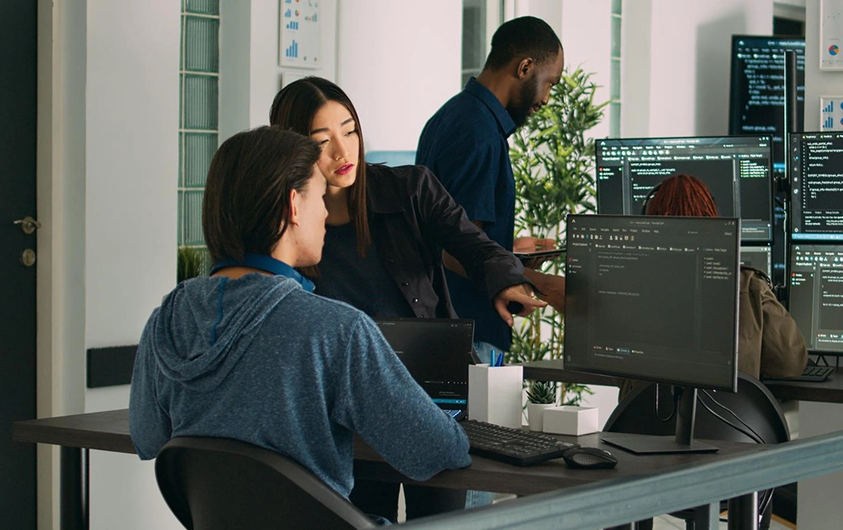 Developer working at workspace with multiple monitors in Singapore